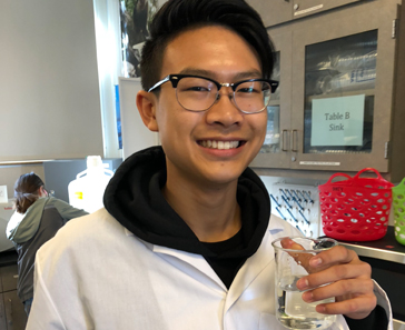 Student with beaker.